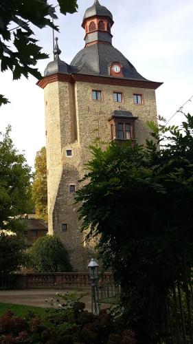 a building with a clock tower on top of it at RUTHMANN-Rheinblick GARNI in Oestrich-Winkel