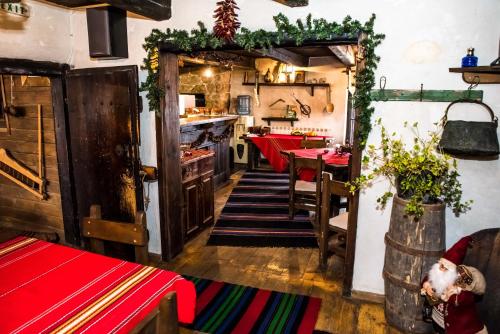 a kitchen and dining room with a table and a kitchen at Banskovilla Zlateva House in Bansko