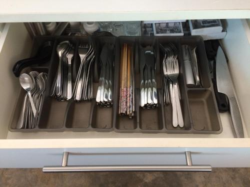 a drawer filled with utensils in a cabinet at Sarang by the brook in Kuala Kubu Baharu