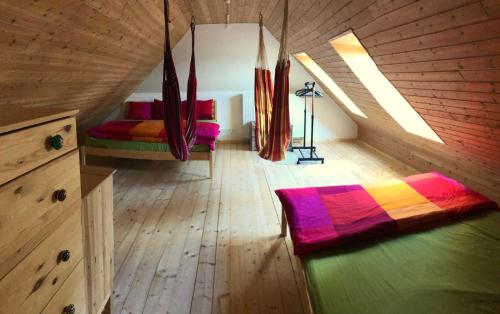 a room with two beds in a wooden cabin at Chata Magistrála in Bedřichov