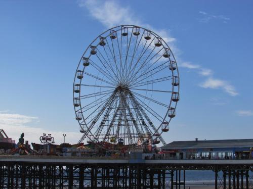 a large ferris wheel on the beach near a pier at Simpson Beach View Apartments by Blackpool Service Apartments in Blackpool