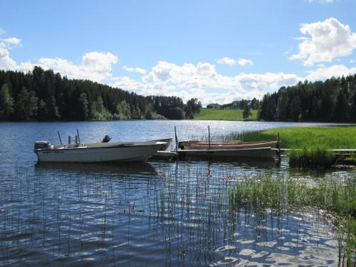 two boats sitting in the water on a lake at Stöde Camping in Edsta