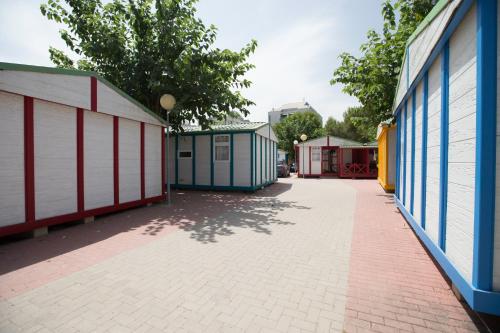 an empty alley with blue and white buildings at Camping Los Llanos in Denia