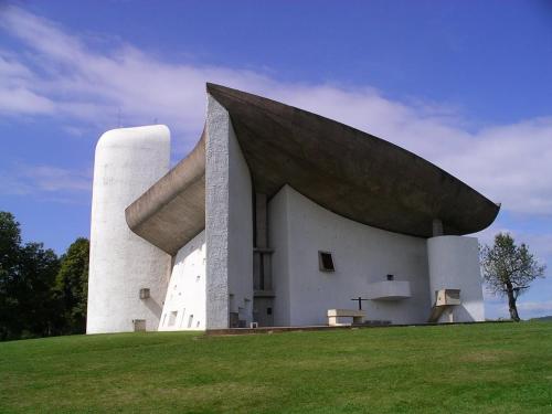 a large white building with aavy roof on a grass field at Hôtel Vauban in Belfort
