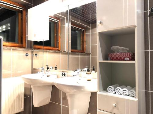 a bathroom with two sinks and a mirror at Sielanka w Brennej in Brenna