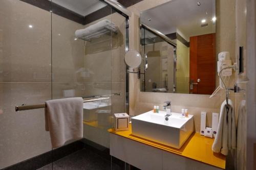 a bathroom with a sink and a mirror at Best Western Summerlea jalandhar in Jalandhar
