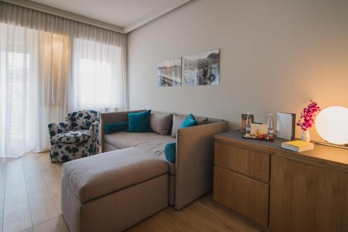 a living room with a couch and a chair at Gallia Palace Hotel - Relais & Châteaux in Punta Ala