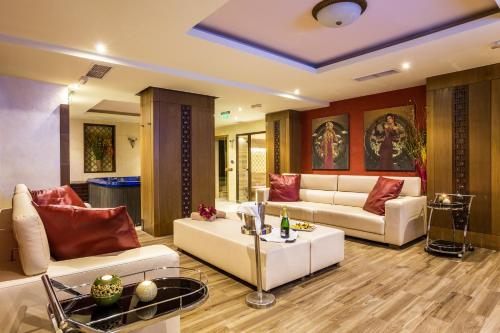 a living room with a couch and a table at Landmark Creek Hotel Plovdiv in Plovdiv
