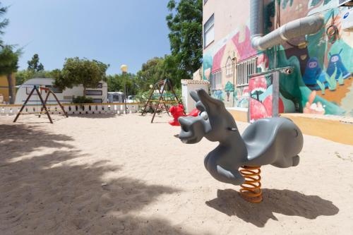 a toy elephant is on a playground at Camping Los Llanos in Denia