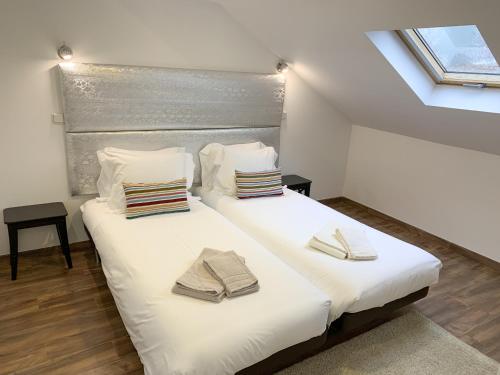 a bedroom with a large white bed with towels on it at LV Premier Amoreiras AM2 in Lisbon
