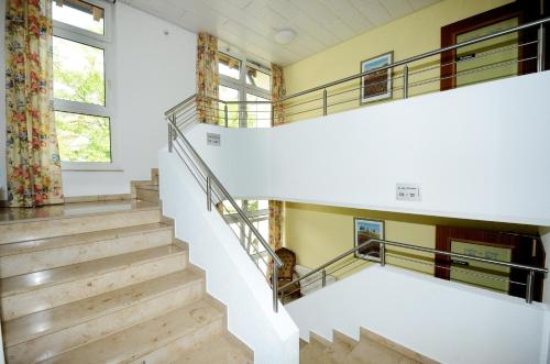 a staircase in a house with wooden floors at Hotel Altbacher Hof in Altbach