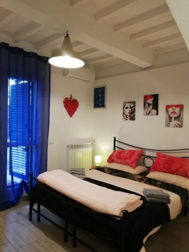 two beds in a room with blue curtains at B & B Eliana in Florence