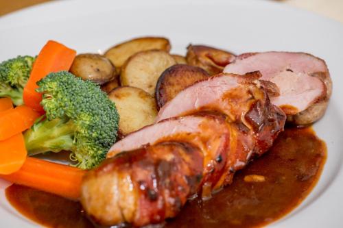 a plate of food with meat potatoes and vegetables at The Black Horse Inn in Louth