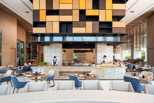 a lobby of a hotel with tables and chairs at Hotel Nikko Bangkok - SHA Extra Plus Certified in Bangkok
