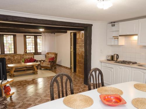a kitchen and living room with a table and chairs at Apartment south in Darłowo