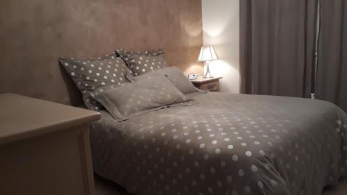 a bedroom with a bed with polka dot pillows at Villa avec vue in Biviers