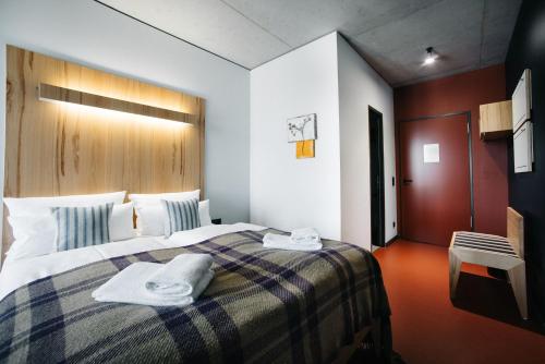 a hotel room with a bed with towels on it at Hotel Rossi in Berlin