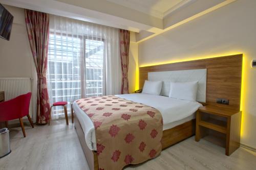 a hotel room with a large bed and a window at Bolu Cadde Otel in Bolu