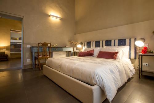 a bedroom with a large bed and a table at La Cotogna in Magione
