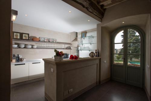 a kitchen with a counter with a window and a door at La Cotogna in Magione