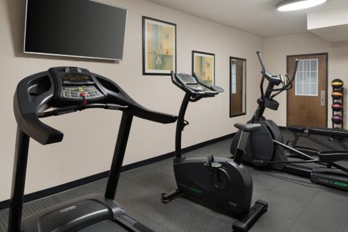 a gym with two exercise bikes and a flat screen tv at Baymont by Wyndham Belleville Airport Area Free Airport Shuttle in Belleville