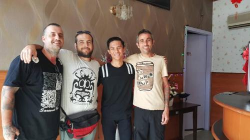 a group of four men posing for a picture at New Orchid Hotel Tuaran in Tuaran