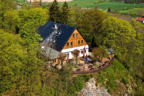 an aerial view of a house in the middle of a hill at Berggasthof Koitsche im Naturpark Zittauer Gebirge in Bertsdorf