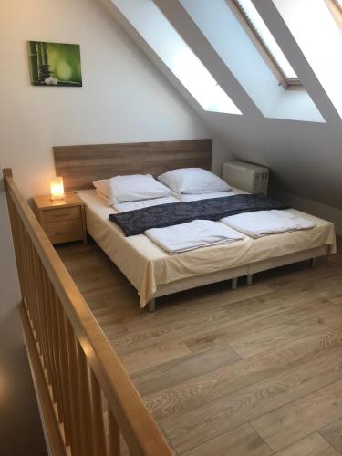 a bedroom with a bed in a attic at Baltic Vip Apartamenty przy morzu in Rewal