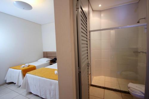 奧林匹亞的住宿－阿古阿維瓦酒店，一间带两张床和淋浴的浴室