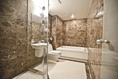 a bathroom with a toilet and a sink and a shower at Hotel Star Gangnam in Seoul