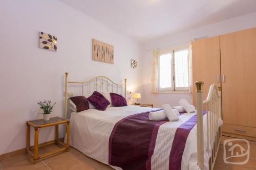 - une chambre avec 2 lits et des oreillers violets dans l'établissement Villa Kelly 6 by Abahana Villas, à Fanadix