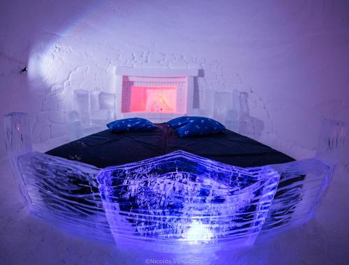 a room with a bed with a blue led lighting at Snowhotel Kirkenes in Kirkenes