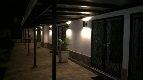 a dark hallway with a door and a potted plant at Urban Lodge in Bujumbura