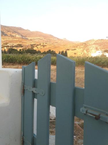 an open gate with a view of a field at ''Sea front'' Rose's house in Kardiani