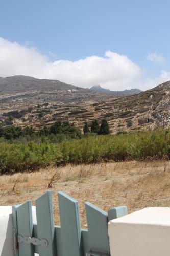 a group of blue chairs in front of a mountain at ''Sea front'' Rose's house in Kardiani