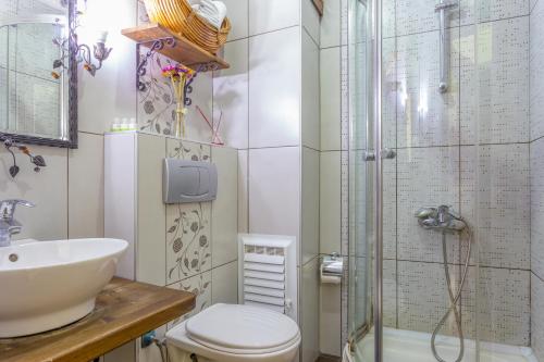 a bathroom with a toilet a sink and a shower at Hotel Sphendon in Istanbul
