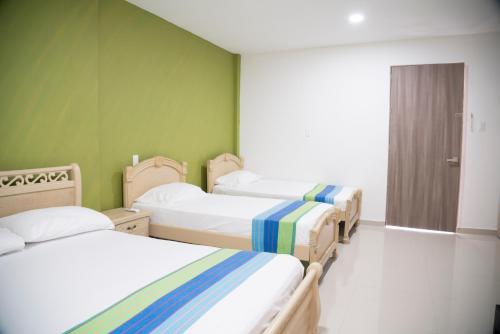 Postel nebo postele na pokoji v ubytování Hotel Emerawaa