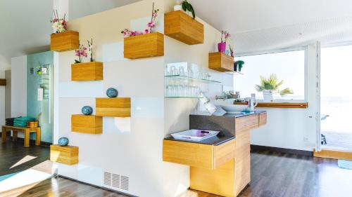a living room with wooden shelves on the wall at Hotel Volapük in Konstanz