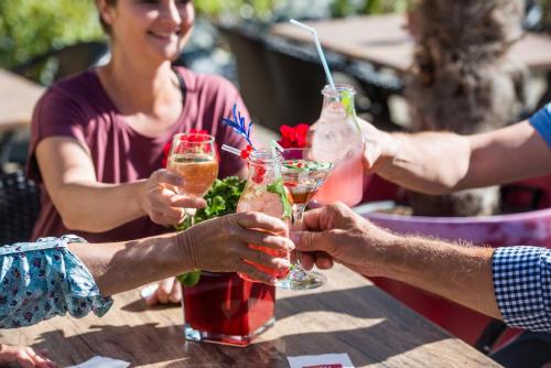 a group of people sitting at a table with drinks at Hotel Volapük in Konstanz