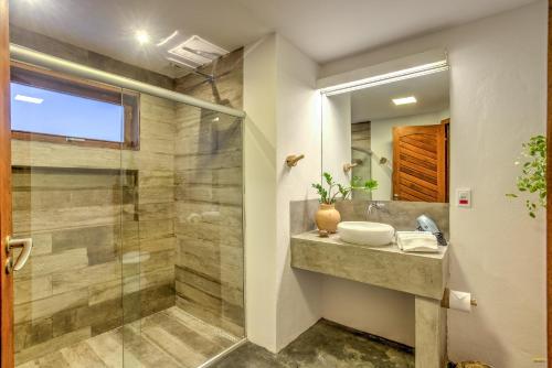 a bathroom with a sink and a shower at A Casa de Gabriella in Itacaré