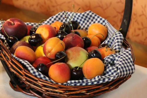 a basket filled with apples and other fruits at Hotel Gasthof Adler in Oberstdorf