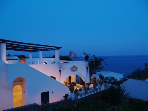 a group of people standing on the stairs of a building at night at Quartara Boutique Hotel in Panarea