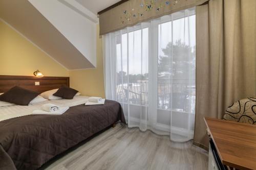 Postel nebo postele na pokoji v ubytování Dom Jastrzębia z basenem i jacuzzi