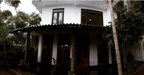 a white house with a window on top of it at Arazo villa in Unawatuna
