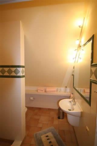 a small bathroom with a sink and a toilet at "Netzboden" by Ferienhaus Strandgut in Born
