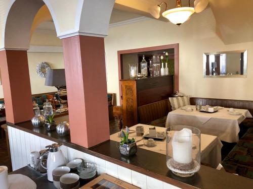 a dining room with two tables in a restaurant at Hotel Hilgers in Düren - Eifel