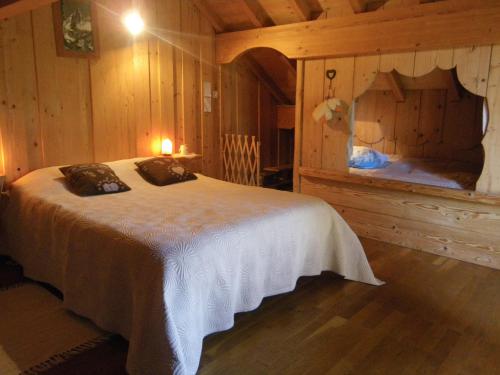 a bedroom with a bed in a wooden room at Chalet de campagne in Sancey-le-Long