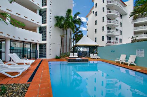 a swimming pool in front of a building at Ocean Boulevard in Alexandra Headland