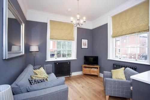 a living room with two couches and a tv at Fossgate Bridge Apartments York in York