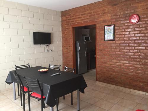 a dining room with a black table and chairs at Casa Nuova Depto DOS y TRES in Villa María